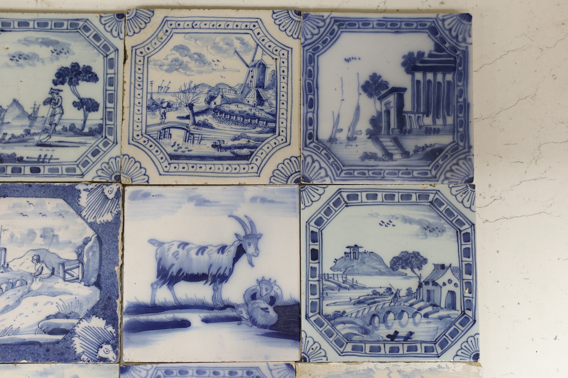 Nine various Delft blue and white landscape or animal tiles, 18th/19th century